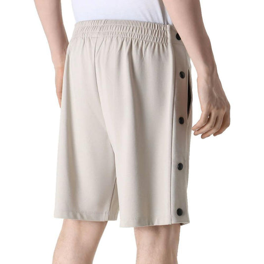 Comme Des Fuckdown beige viscose shorts with elastic waistband, slit pockets, decorative buttons, and side logo embroidery.