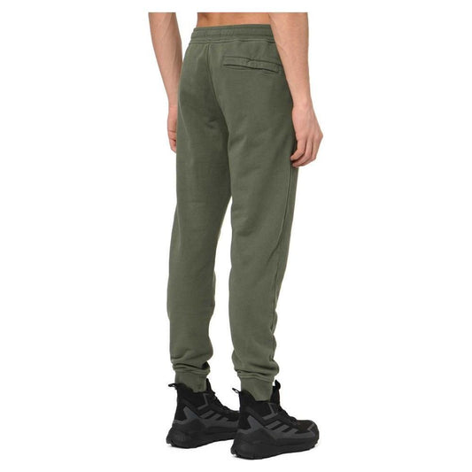 Back view of man wearing olive green joggers with black sneakers, showcasing a relaxed fit and pocket design for modern style.