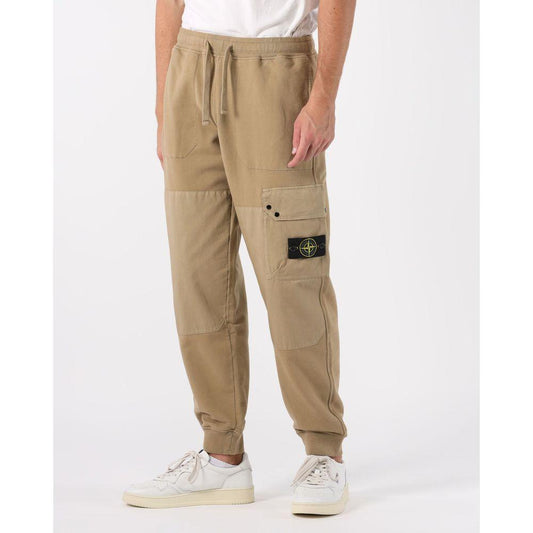 Stone Island beige cotton men's cargo trousers with tri-pocket design and signature badge, paired with white sneakers.