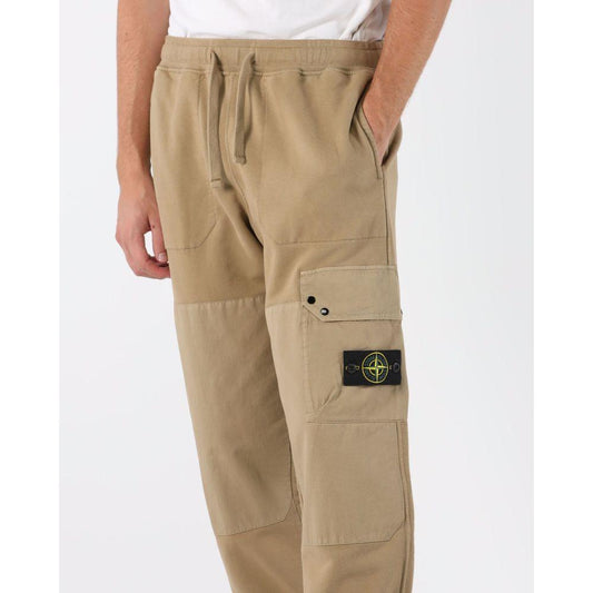 Stone Island beige cotton cargo trousers for men with tri-pocket design and signature badge, shown from the side view.